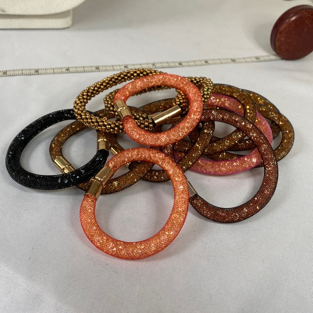 Large group of 12 sparkly magnetic closure bracelets